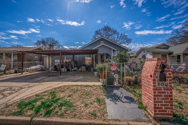 view of front of property featuring driveway and fence