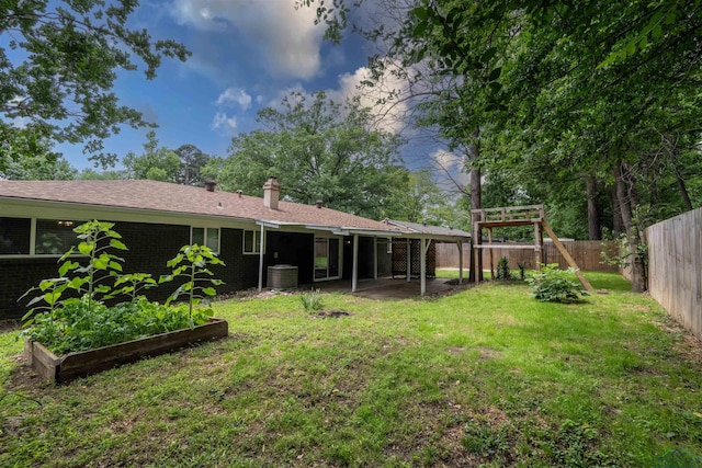 1005 Coushatta Trl, Longview, TX 75605 - view of yard with a garden, central AC unit, and a patio