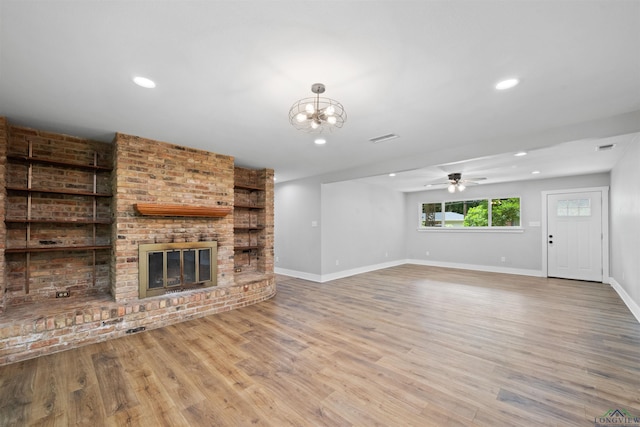 1005 Coushatta Trl, Longview, TX 75605 - unfurnished living room with a fireplace, wood finished floors, baseboards, ceiling fan, and recessed lighting