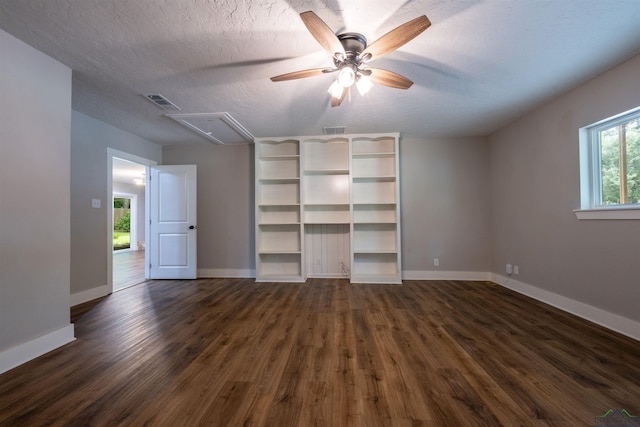 1005 Coushatta Trl, Longview, TX 75605 - unfurnished bedroom with attic access, dark wood-style floors, baseboards, a textured ceiling, and ceiling fan