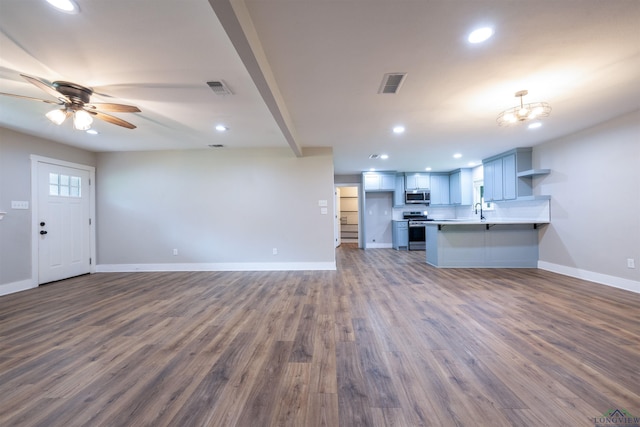 1005 Coushatta Trl, Longview, TX 75605 - unfurnished living room featuring recessed lighting, baseboards, dark wood finished floors, a sink, and ceiling fan