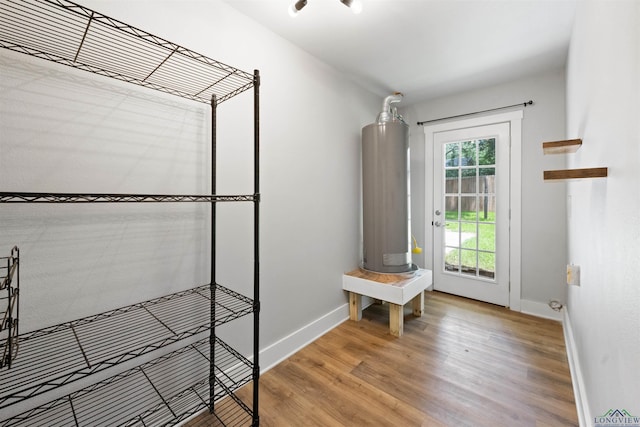 1005 Coushatta Trl, Longview, TX 75605 - mudroom with water heater, wood finished floors, and baseboards