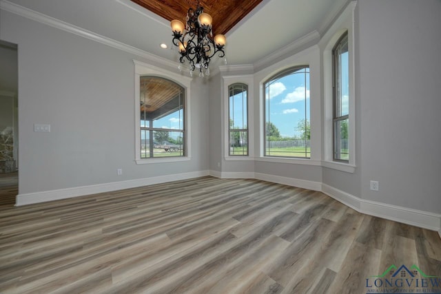 unfurnished room with crown molding, plenty of natural light, and light hardwood / wood-style floors