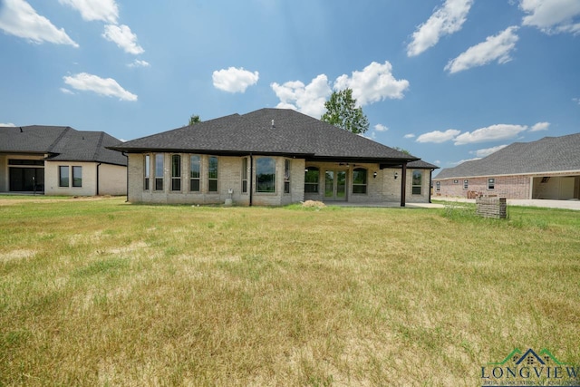 rear view of house featuring a yard