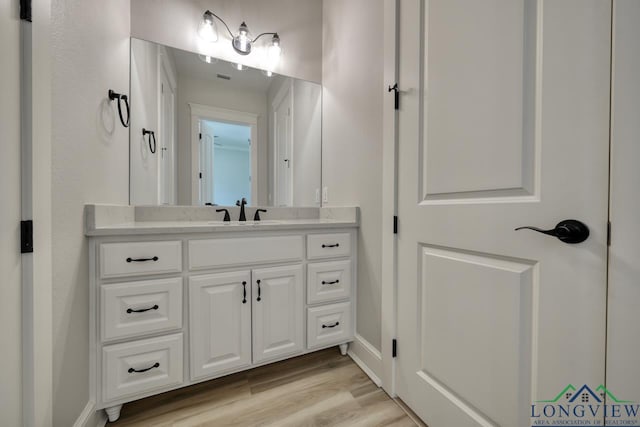 bathroom featuring vanity and hardwood / wood-style floors