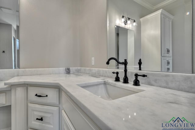 bathroom with ornamental molding and vanity