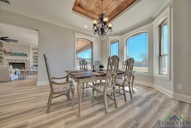 dining room featuring ornamental molding, a healthy amount of sunlight, and light hardwood / wood-style flooring