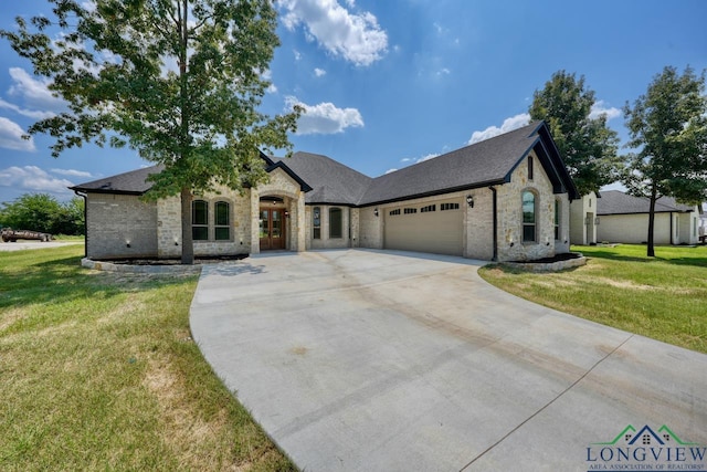 view of front of home featuring a garage and a front lawn