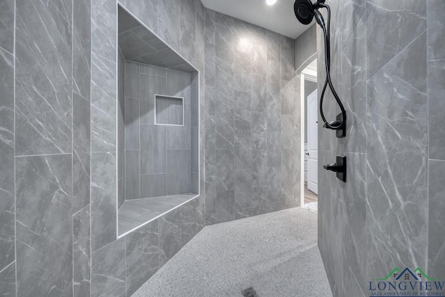 bathroom with a tile shower