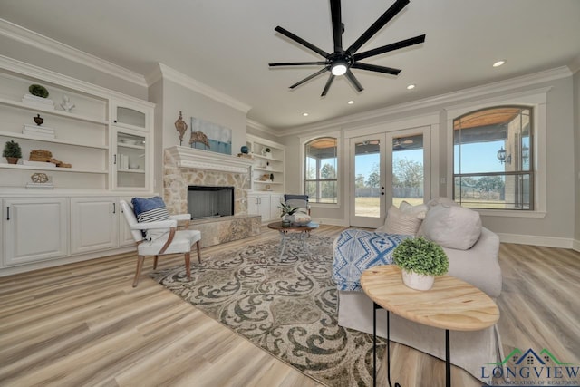 living room featuring crown molding, light hardwood / wood-style floors, and french doors