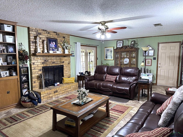 906 Misty Ln, Atlanta, TX 75551 - living room with a ceiling fan, a textured ceiling, and a fireplace