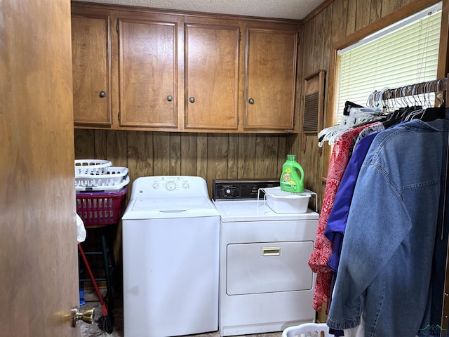 906 Misty Ln, Atlanta, TX 75551 - washroom with separate washer and dryer, cabinet space, and wooden walls