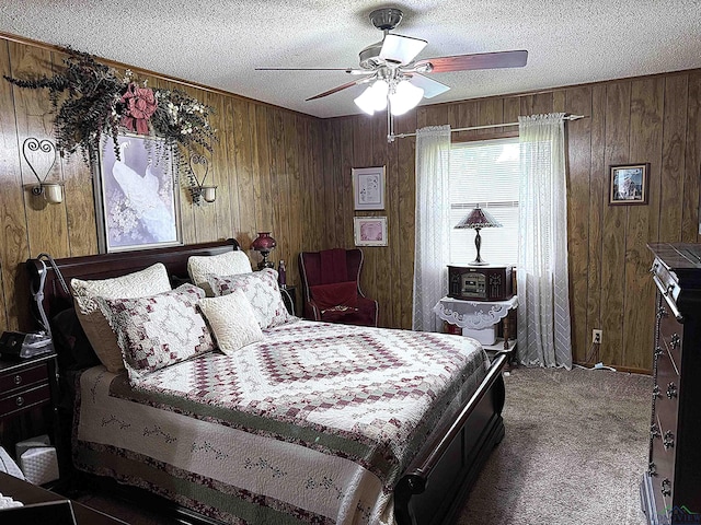 906 Misty Ln, Atlanta, TX 75551 - bedroom featuring wood walls, carpet floors, a textured ceiling, and ceiling fan