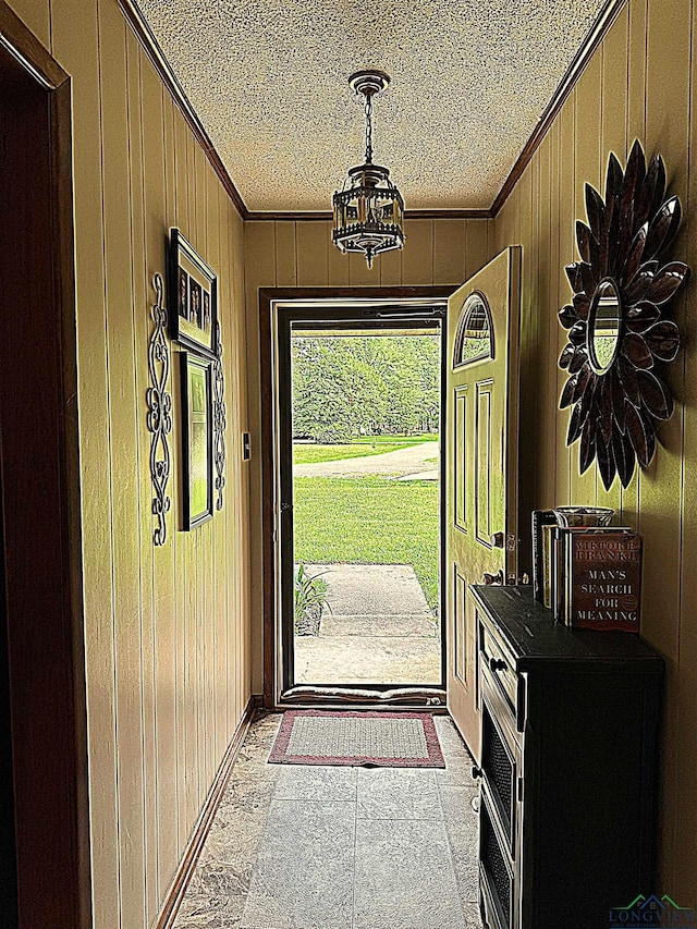 906 Misty Ln, Atlanta, TX 75551 - foyer featuring crown molding, wood walls, and a textured ceiling