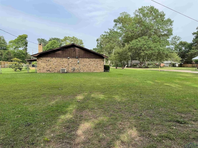 906 Misty Ln, Atlanta, TX 75551 - view of home's exterior featuring a chimney and brick siding