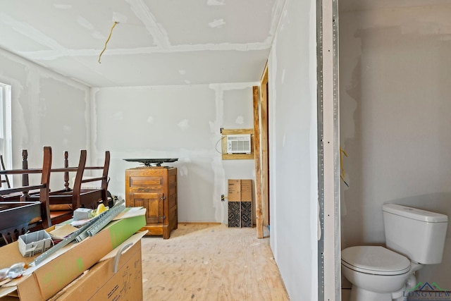 bathroom featuring hardwood / wood-style flooring and toilet