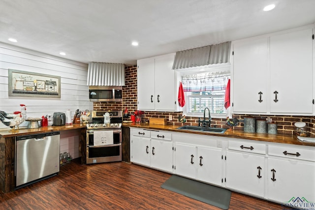 kitchen featuring white cabinetry, appliances with stainless steel finishes, sink, and dark hardwood / wood-style floors