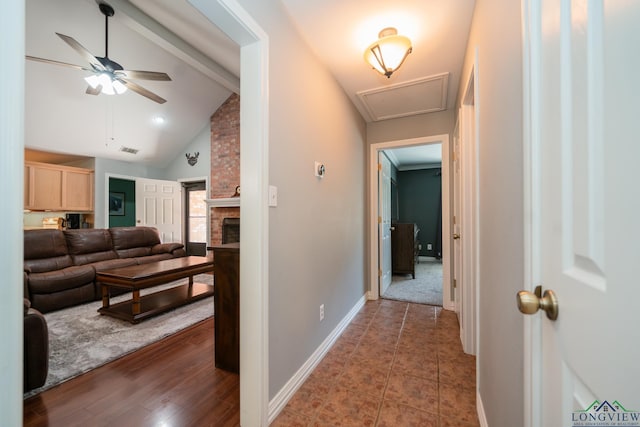 hallway featuring lofted ceiling with beams and dark hardwood / wood-style flooring