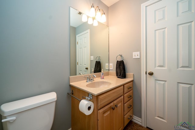 bathroom featuring vanity and toilet