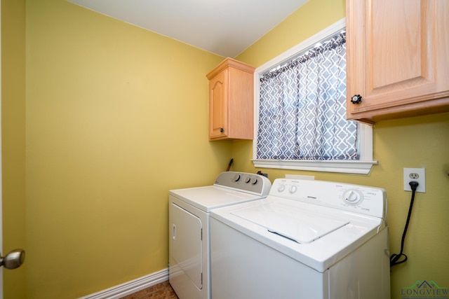 laundry area featuring washing machine and dryer and cabinets