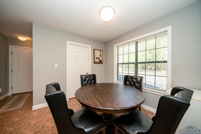 dining area with light tile patterned flooring