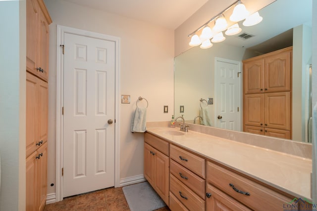 bathroom with tile patterned flooring and vanity