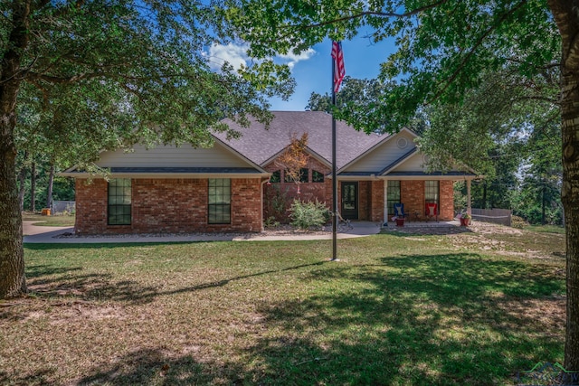 view of front of house featuring a front yard, fence, and brick siding