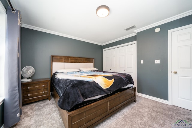 carpeted bedroom featuring crown molding and a closet