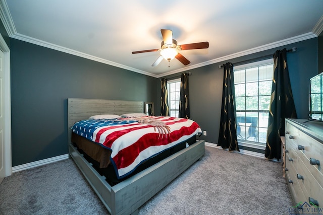 carpeted bedroom with ceiling fan, ornamental molding, and multiple windows