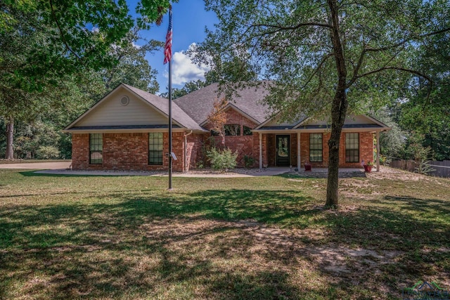 ranch-style home featuring a front yard