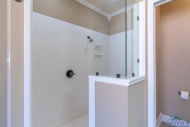 full bath with ornamental molding, baseboards, and walk in shower