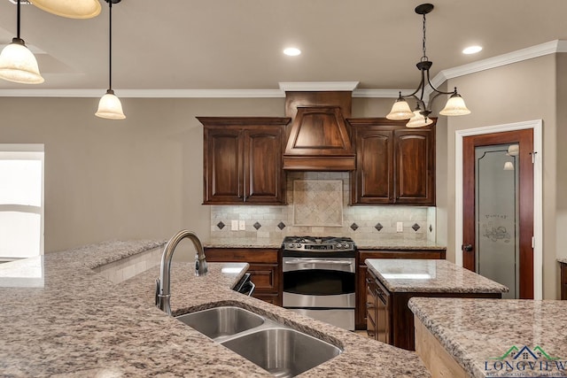 kitchen featuring light stone counters, a sink, tasteful backsplash, gas stove, and custom exhaust hood