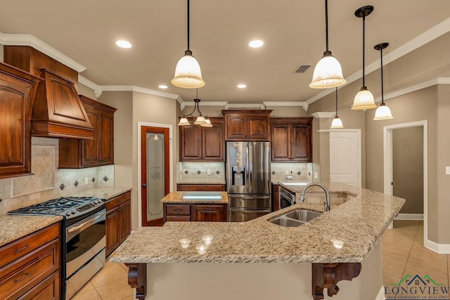 kitchen featuring visible vents, a large island with sink, appliances with stainless steel finishes, custom exhaust hood, and a sink