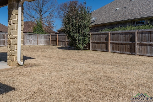 view of yard with a fenced backyard