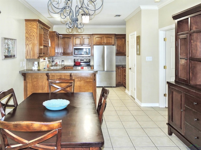204 Widgeon Rd, Gilmer, TX 75645 - kitchen with appliances with stainless steel finishes, a chandelier, decorative backsplash, ornamental molding, and light tile patterned floors
