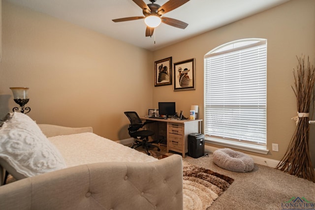 carpeted bedroom featuring multiple windows and ceiling fan