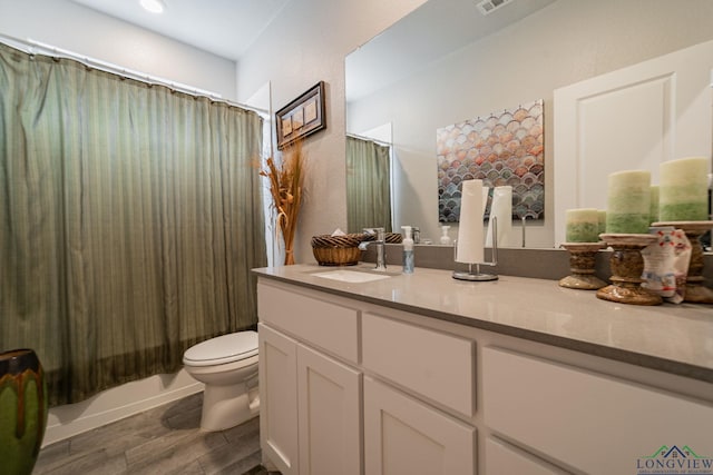 full bathroom with vanity, toilet, and shower / bath combo