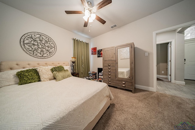 bedroom with ceiling fan and light carpet