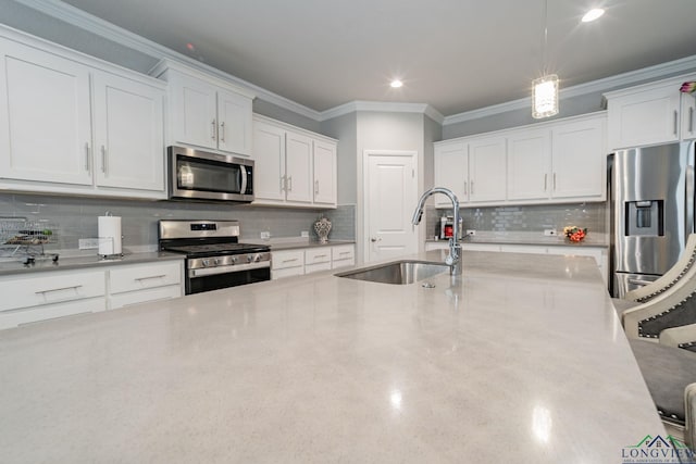 kitchen featuring white cabinets, sink, stainless steel appliances, and tasteful backsplash