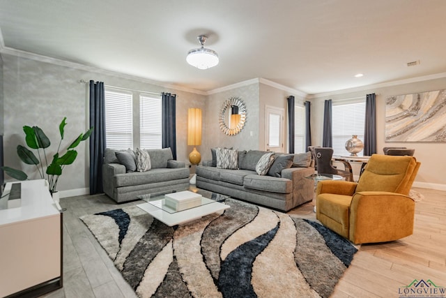 living room featuring plenty of natural light, light hardwood / wood-style floors, and crown molding