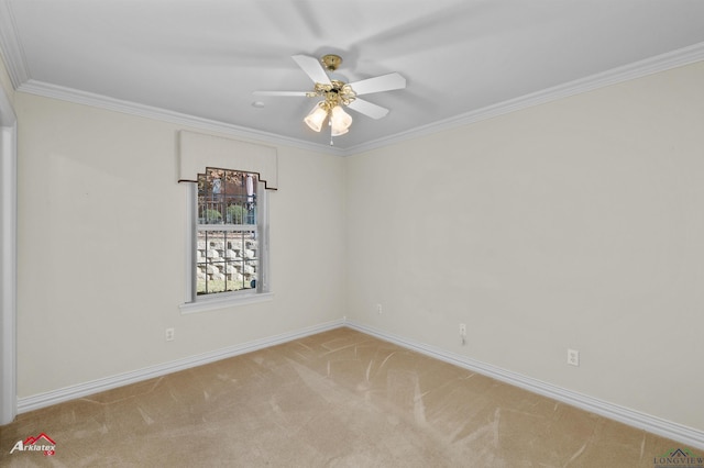 spare room featuring ceiling fan, light colored carpet, and crown molding