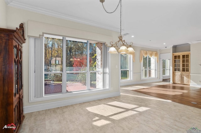 unfurnished dining area with ornamental molding, plenty of natural light, and a notable chandelier