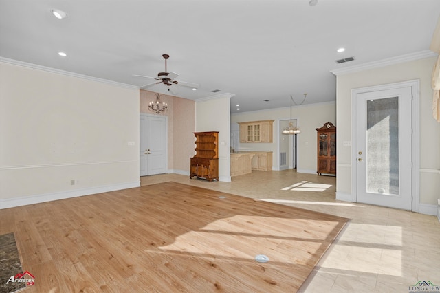 unfurnished living room featuring ceiling fan with notable chandelier, light hardwood / wood-style floors, and crown molding