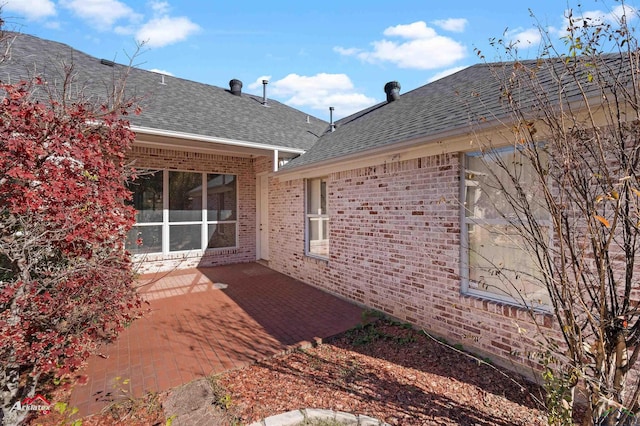 view of side of property with a patio area