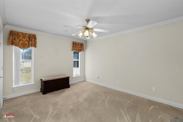 carpeted spare room with crown molding and ceiling fan