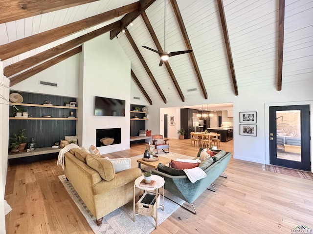 3 Lindsey Ln, Longview, TX 75601 - living area with light wood-type flooring, high vaulted ceiling, a chandelier, a wood ceiling with exposed beams, and a fireplace