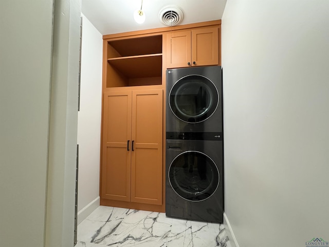 3 Lindsey Ln, Longview, TX 75601 - laundry area featuring stacked washing machine and dryer, light marble finish floors, and cabinet space