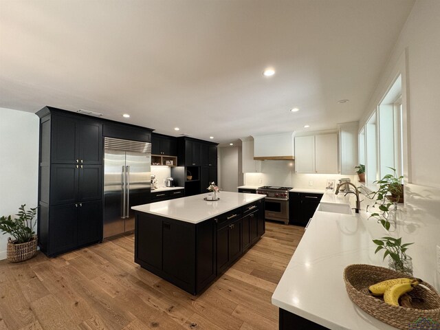 3 Lindsey Ln, Longview, TX 75601 - kitchen with high quality appliances, dark cabinetry, light countertops, a center island, and recessed lighting