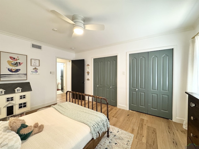 3 Lindsey Ln, Longview, TX 75601 - bedroom with multiple closets, crown molding, light wood-style floors, and a ceiling fan