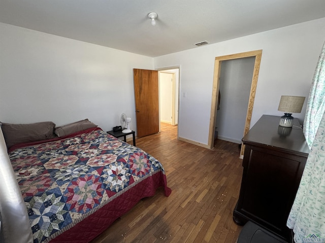 bedroom featuring dark hardwood / wood-style flooring